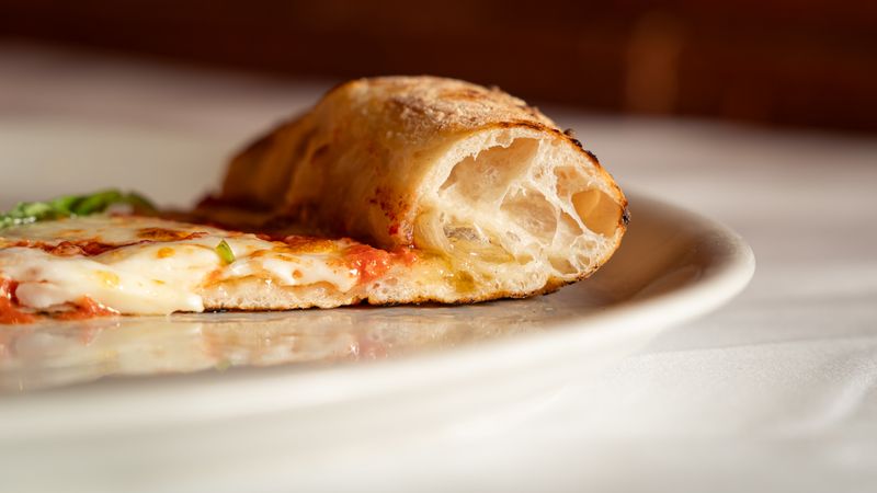 Dewey's Meat Lovers pizza stacked with premium meats